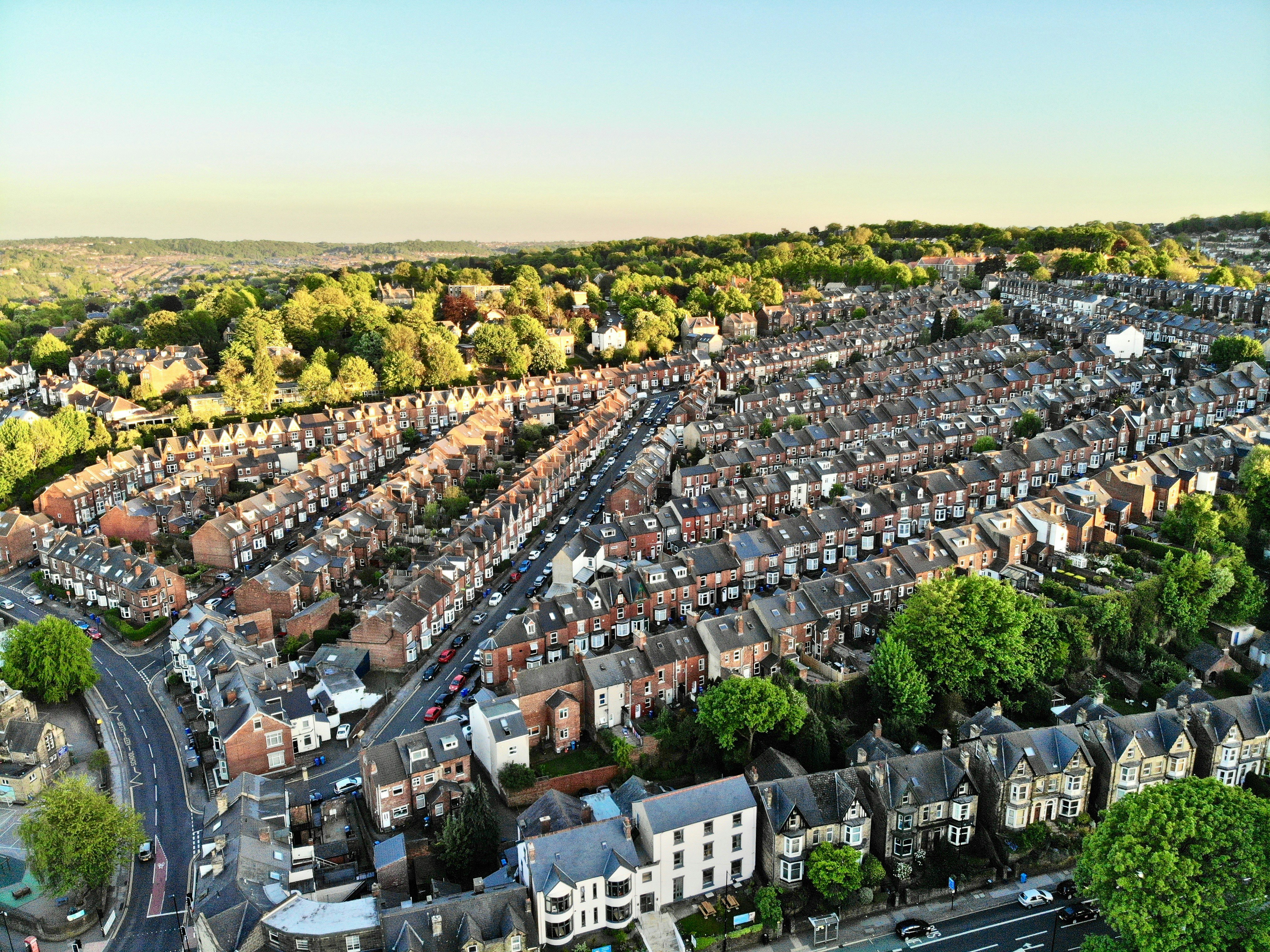 Aerial view of red-brick terraced homes and rooftops in a UK city